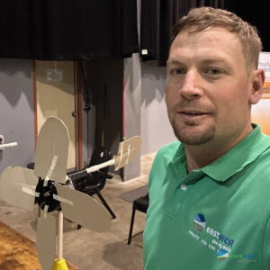 Matt Grinter at the wind turbine station with one of the wind turbine creations